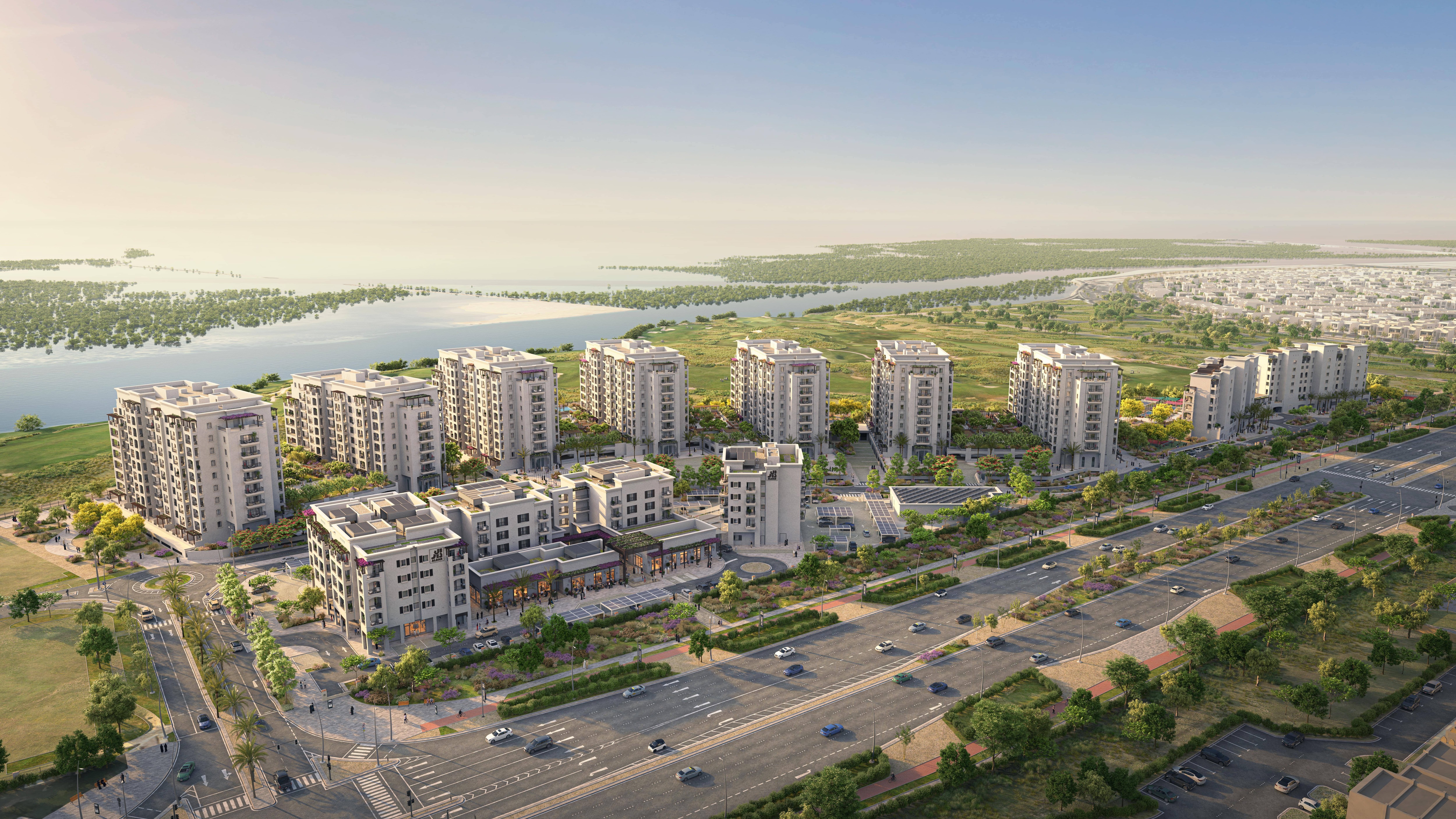 Aerial of Yas Golf Collection buildings nestled between golf course and mangroves.