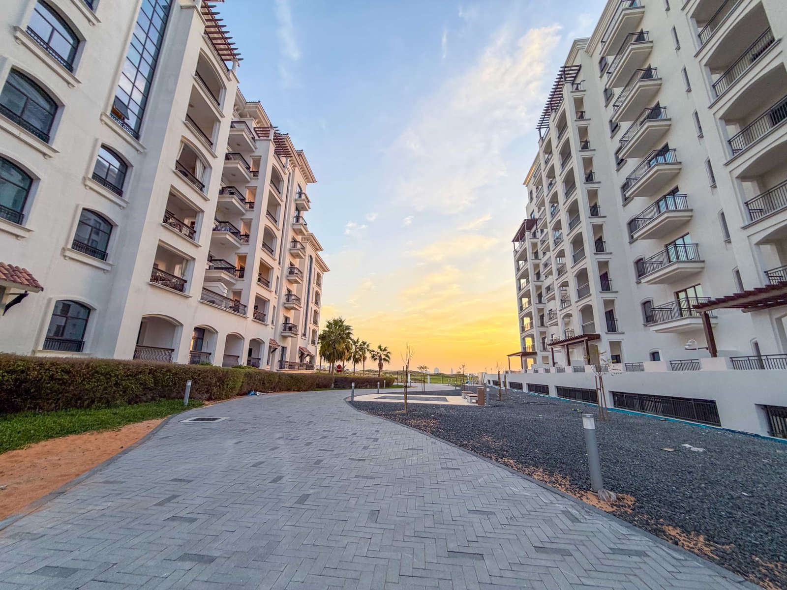Modern apartments at Yas Golf Collection with sunlit terraces overlooking manicured golf fairways and serene mangrove landscapes.