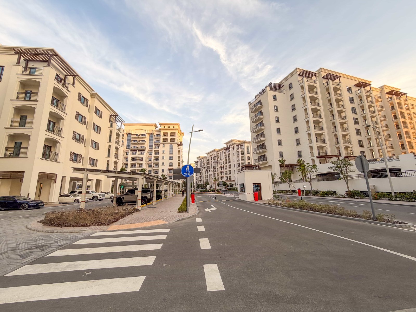 Aerial view of Yas Golf Collection residences showcasing lush podium gardens, golf course, and mangrove vistas on Yas Island.